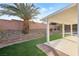 Covered patio features artificial turf, palm trees, and well-maintained landscaping at 116 Crescent Bay St, Henderson, NV 89012