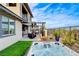 Beautiful backyard with a hot tub, covered patio, desert landscaping, and an area for outdoor seating and relaxation at 12355 Grey Dunes Ave, Las Vegas, NV 89138
