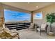 Open air balcony with comfortable seating and scenic views of the surrounding landscape and mountains at 12355 Grey Dunes Ave, Las Vegas, NV 89138