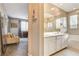 Bright bathroom featuring double sinks, a large mirror, and separate tub and shower at 12355 Grey Dunes Ave, Las Vegas, NV 89138