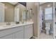 Clean bathroom featuring a double sink vanity, a large mirror, and a toilet at 12355 Grey Dunes Ave, Las Vegas, NV 89138