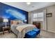 Stylish bedroom with a unique galaxy mural, cozy bed, and coordinating side tables at 12355 Grey Dunes Ave, Las Vegas, NV 89138