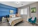 Charming bedroom with blue accent wall, comfortable bed, and decorative bedside table at 12355 Grey Dunes Ave, Las Vegas, NV 89138