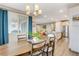 Dining area leading to kitchen, featuring hardwood floors and lots of natural light from windows at 12355 Grey Dunes Ave, Las Vegas, NV 89138
