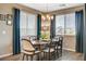 Stylish dining room with hardwood floors, neutral walls, and natural light from large windows at 12355 Grey Dunes Ave, Las Vegas, NV 89138