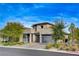 Contemporary two-story home with three-car garage and desert landscaping at 12355 Grey Dunes Ave, Las Vegas, NV 89138