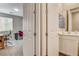 Hallway view leading to a bathroom and office space through paneled doors at 12355 Grey Dunes Ave, Las Vegas, NV 89138
