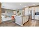 Spacious open kitchen with stainless steel appliances, center island, and seamless flow into the living area at 12355 Grey Dunes Ave, Las Vegas, NV 89138