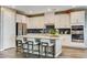 Sleek white kitchen featuring an island with bar seating and modern appliances at 12355 Grey Dunes Ave, Las Vegas, NV 89138