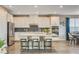 Bright kitchen with quartz counters, island seating, and stainless steel appliances at 12355 Grey Dunes Ave, Las Vegas, NV 89138
