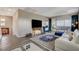 Cozy living room with stylish rug, modern furniture, and sliding glass doors to a balcony at 12355 Grey Dunes Ave, Las Vegas, NV 89138