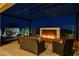 Cozy outdoor patio with a modern fire feature, comfortable seating, and ambient lighting at 12355 Grey Dunes Ave, Las Vegas, NV 89138