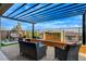Outdoor patio with a water feature, comfortable seating, and a modern pergola at 12355 Grey Dunes Ave, Las Vegas, NV 89138
