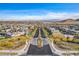 A wide view of the community featuring multiple homes, manicured landscaping, and street scape at 12355 Grey Dunes Ave, Las Vegas, NV 89138