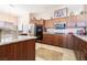 Well-lit kitchen with stainless steel appliances, light countertops, and rich wood cabinets at 1259 N Hollywood Blvd, Las Vegas, NV 89110
