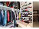 Organized walk-in closet with clothing racks, shelves, and a seating bench at 1259 N Hollywood Blvd, Las Vegas, NV 89110