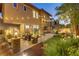 Expansive backyard featuring a putting green, stone patio with seating, and a built-in outdoor kitchen at 1272 Olivia Pkwy, Henderson, NV 89011