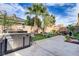 Spacious backyard featuring a built-in outdoor kitchen, putting green, and decorative landscaping at 1272 Olivia Pkwy, Henderson, NV 89011
