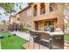 Beautiful backyard featuring an outdoor kitchen, mini golf course, and covered patio with a ceiling fan at 1272 Olivia Pkwy, Henderson, NV 89011