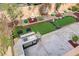 Landscaped backyard oasis featuring a built-in grill, putting green, and outdoor seating area at 1272 Olivia Pkwy, Henderson, NV 89011
