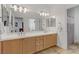 Bright bathroom with a double sink vanity, large mirror, and a separate shower area at 1272 Olivia Pkwy, Henderson, NV 89011