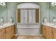 Bathroom featuring double vanity sinks, a soaking tub with plantation shutters, and tile flooring at 1272 Olivia Pkwy, Henderson, NV 89011