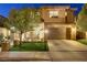 Inviting two-story home with an appealing front yard, complete with lush trees and a neatly maintained lawn at 1272 Olivia Pkwy, Henderson, NV 89011