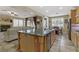 Open-concept kitchen flows into the living area, featuring a large island and stainless steel appliances at 1272 Olivia Pkwy, Henderson, NV 89011