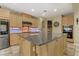 Spacious kitchen features custom cabinets, granite countertops, stainless steel appliances, and island at 1272 Olivia Pkwy, Henderson, NV 89011