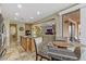 Bright and open kitchen area with an island, eat-in table and view of the living room and fireplace at 1272 Olivia Pkwy, Henderson, NV 89011