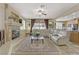Open living room with a fireplace, plush seating, and seamless access to the kitchen at 1272 Olivia Pkwy, Henderson, NV 89011