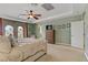 Main bedroom featuring tan carpet, ceiling fan, and access to a balcony at 1272 Olivia Pkwy, Henderson, NV 89011