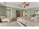 Main bedroom featuring neutral carpet, tray ceilings, ceiling fan, and en-suite bathroom at 1272 Olivia Pkwy, Henderson, NV 89011