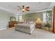 Spacious main bedroom with tan carpet, ceiling fan, and a sliding door to the balcony at 1272 Olivia Pkwy, Henderson, NV 89011