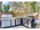 Modern outdoor kitchen with stainless steel appliances, a built-in grill, and ample counter space at 1272 Olivia Pkwy, Henderson, NV 89011