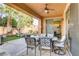 Inviting covered patio with comfortable seating, outdoor kitchen, and lush landscaping at 1272 Olivia Pkwy, Henderson, NV 89011