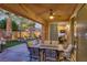 Covered patio featuring an outdoor dining table, fountain, and views of lush landscaping and putting green at 1272 Olivia Pkwy, Henderson, NV 89011