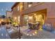 Outdoor patio featuring built-in grill and sink, dining set, and view to living room through sliding doors at 1272 Olivia Pkwy, Henderson, NV 89011