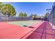 Brightly lit tennis court ready for a match under a clear blue sky at 1272 Olivia Pkwy, Henderson, NV 89011