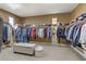 Large walk-in closet with extensive storage and a center ottoman at 1272 Olivia Pkwy, Henderson, NV 89011