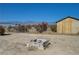 A rustic backyard space includes a stone firepit, offering a cozy outdoor area for gatherings at 1450 Fern St, Pahrump, NV 89060