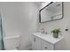 Bathroom featuring sleek vanity, modern fixtures, and decorative mirror at 1450 Fern St, Pahrump, NV 89060