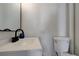 A clean, simple bathroom with white fixtures, including a toilet and sink at 1450 Fern St, Pahrump, NV 89060