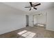 An ample bedroom featuring carpeting, a ceiling fan, and a mirrored closet at 1450 Fern St, Pahrump, NV 89060