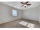 Inviting bedroom with a bright window and neutral carpet at 1450 Fern St, Pahrump, NV 89060
