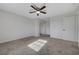 Bright bedroom featuring neutral walls, carpet, and a ceiling fan with overhead lighting at 1450 Fern St, Pahrump, NV 89060