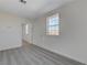 A bright bedroom with a large window and multiple doors leading to other rooms at 1450 Fern St, Pahrump, NV 89060