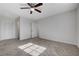 Bright bedroom featuring neutral walls, carpet, and a ceiling fan with overhead lighting at 1450 Fern St, Pahrump, NV 89060