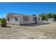 Inviting single-story home with a blue door and a fenced deck on a spacious lot at 1450 Fern St, Pahrump, NV 89060
