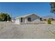 Quaint one-story home with a gravel driveway, mountain views, and a covered porch at 1450 Fern St, Pahrump, NV 89060
